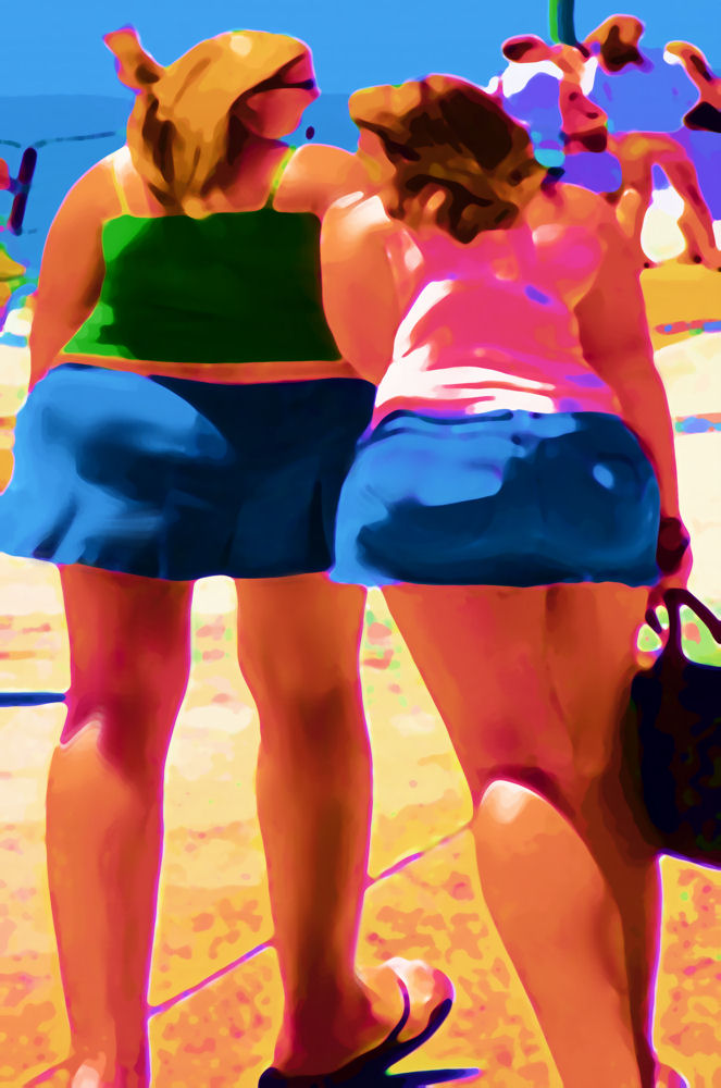 rear view image of two girls at the seaside in bright candy colours